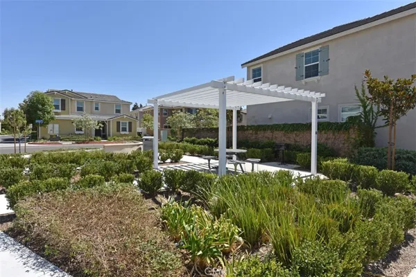 a view of a patio with table and chairs and potted plants