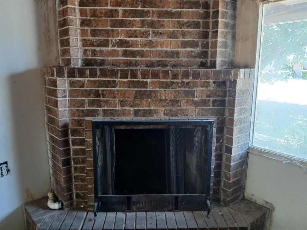 2010 Nowlin Road Coleman, TX 76834 - Photo 2 of 7 a room with granite countertop a stove and a shower