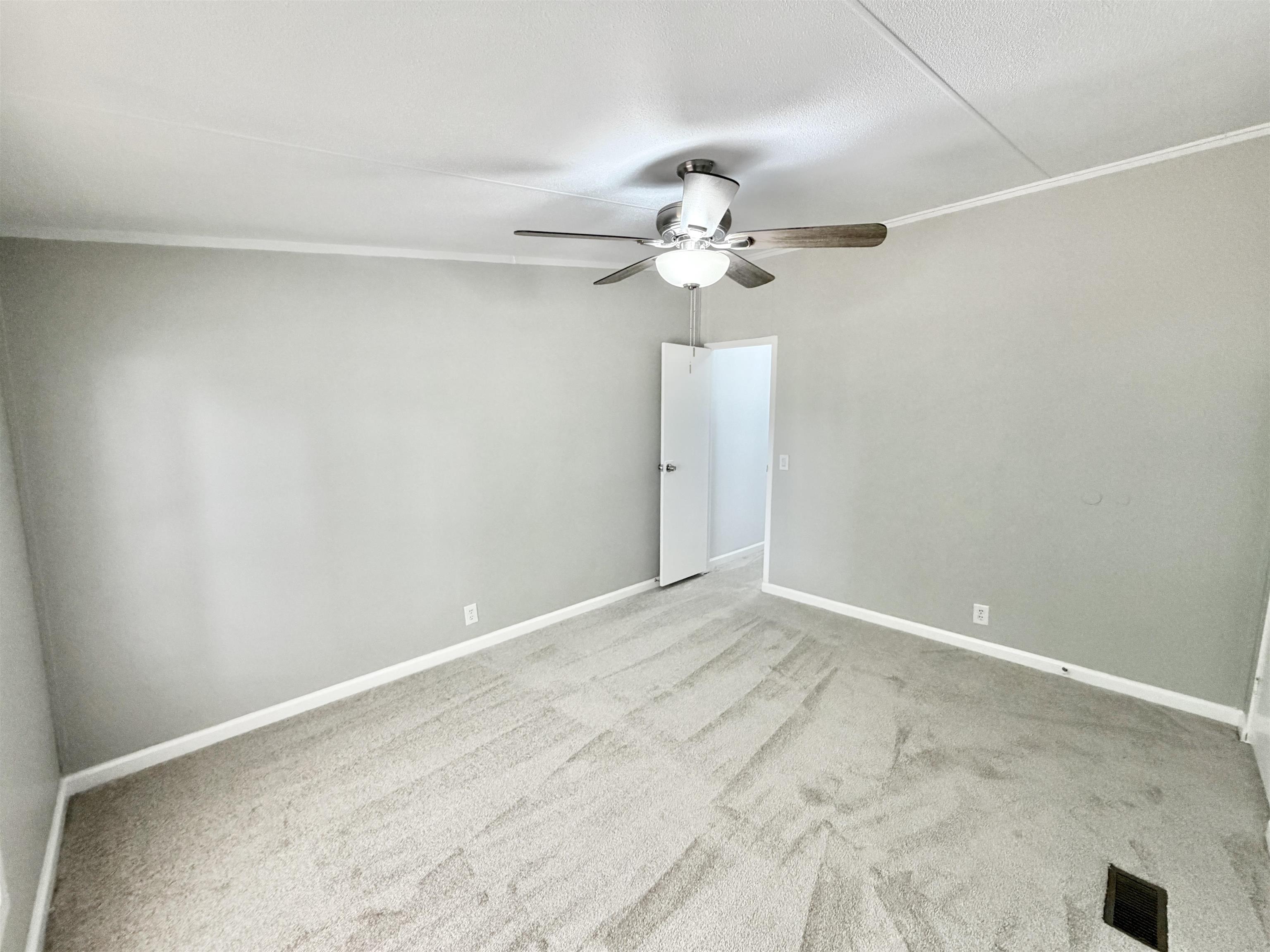 1655 Fayne Road Brighton, TN 38011 - Photo 17 of 28 Spacious room featuring light gray wall paint, light-toned carpeting, and white baseboards