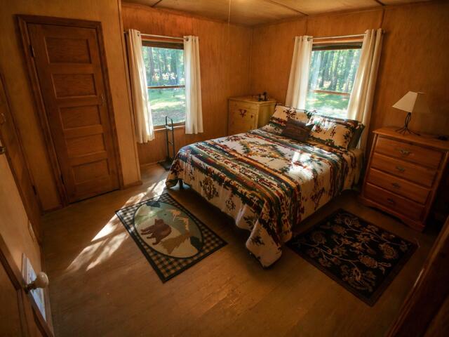 80 Diamond Lake Loop Chemult, OR 97731 - Photo 16 of 36 a bed sitting in a bedroom next to a window