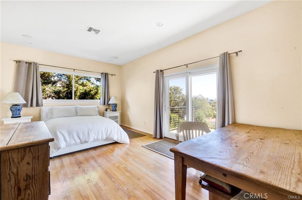 5084 Campo Road Los Angeles, CA 91364 - Photo 20 of 29 a bedroom with a bed and wooden floor