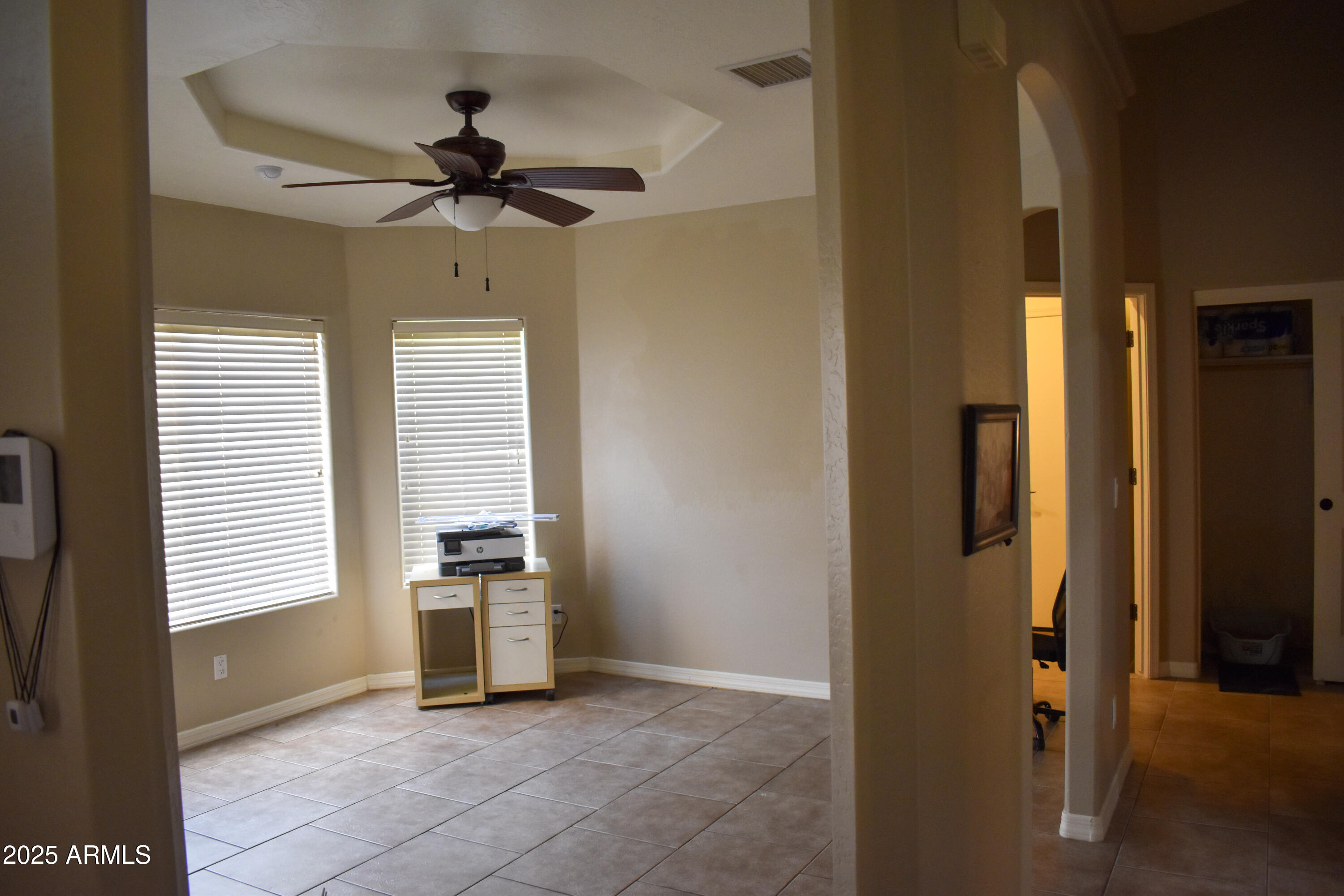 15641 Coral Road Arizona City, AZ 85123 - Photo 5 of 10 a view of a livingroom with a ceiling fan and window