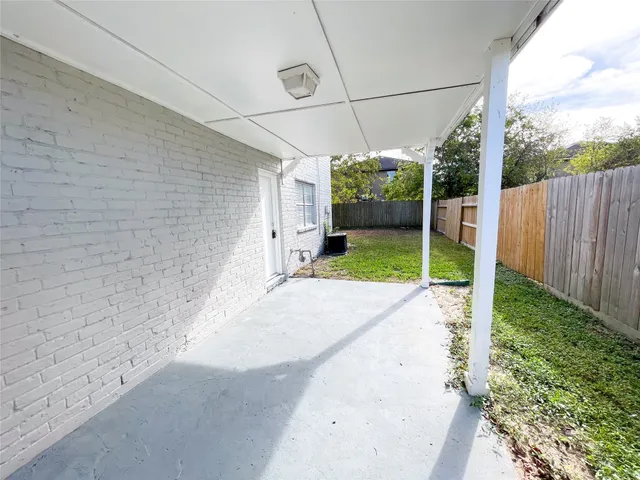 a view of a backyard with wooden fence