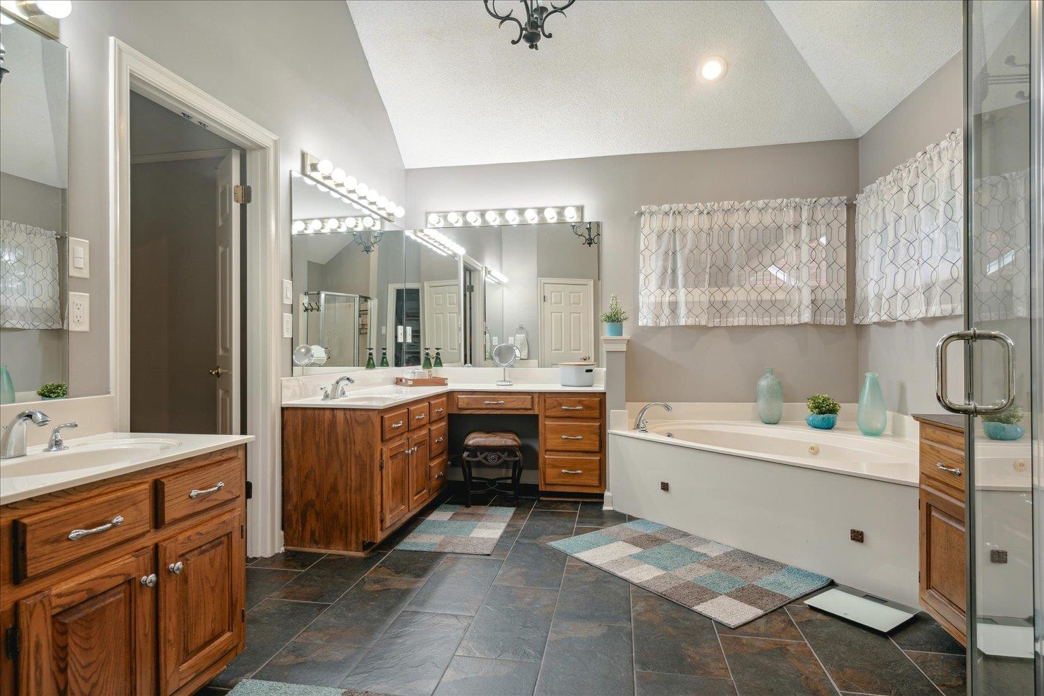 8450 Thor Road Memphis, TN 38018 - Photo 23 of 32 Bathroom with vanity, lofted ceiling, and plus walk in shower