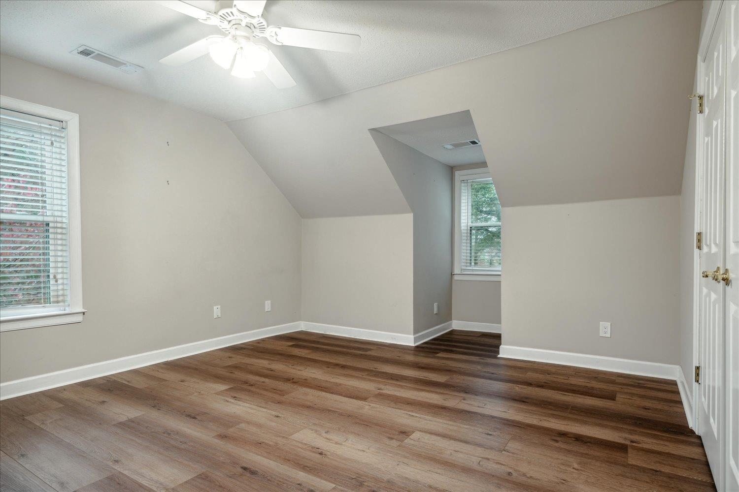 8450 Thor Road Memphis, TN 38018 - Photo 24 of 32 Additional living space with a textured ceiling, ceiling fan, vaulted ceiling, and hardwood / wood-style flooring