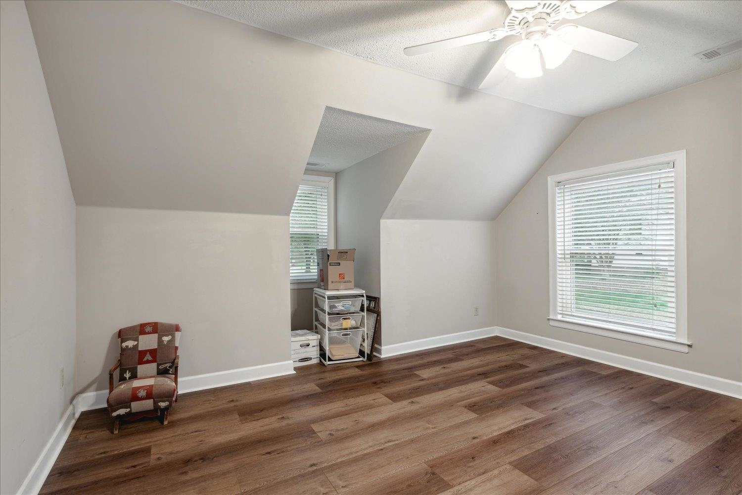 8450 Thor Road Memphis, TN 38018 - Photo 26 of 32 Bonus room featuring ceiling fan, dark wood-type flooring, a wealth of natural light, and vaulted ceiling