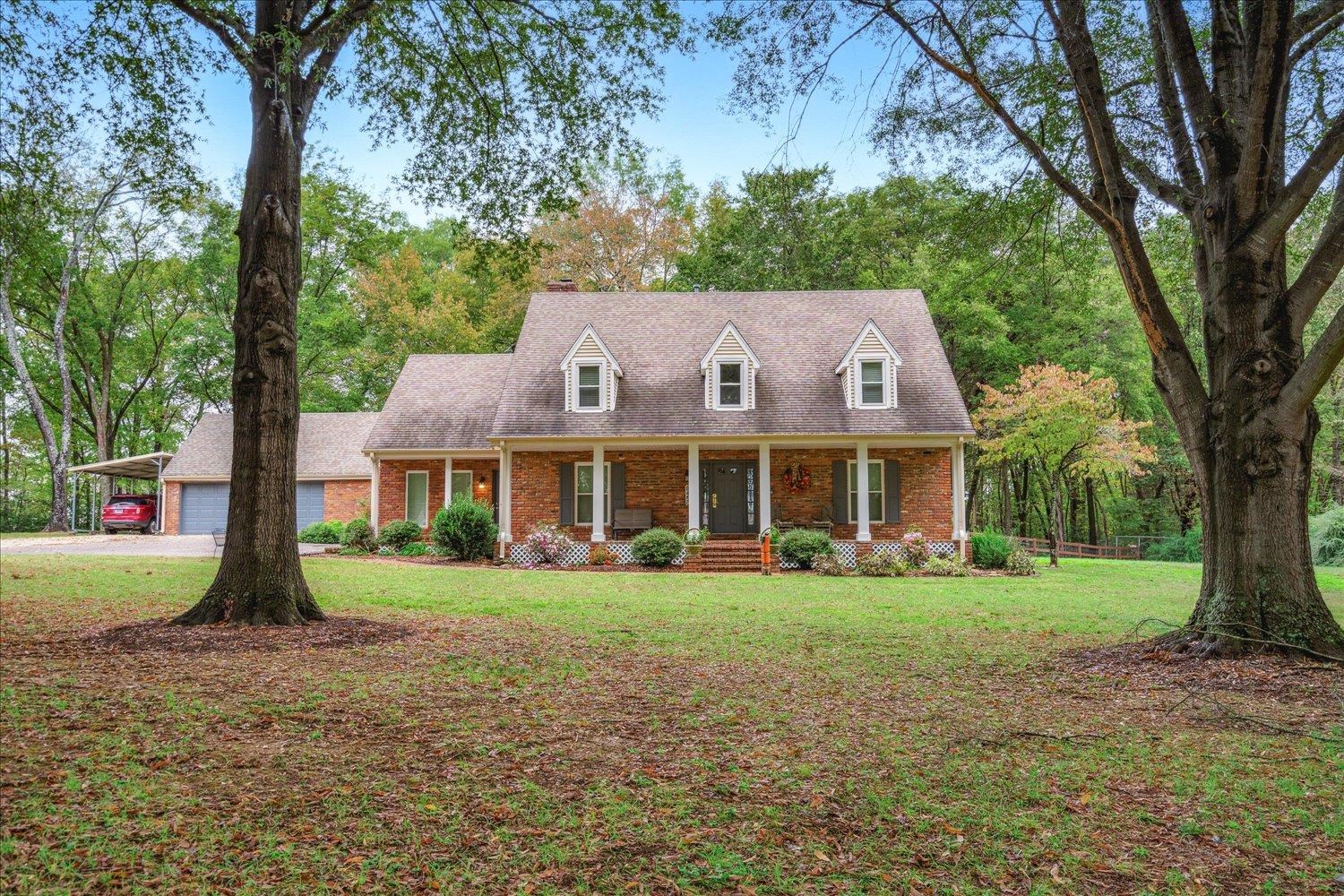 8450 Thor Road Memphis, TN 38018 - Photo 3 of 32 New england style home featuring a front lawn, covered porch, and a carport