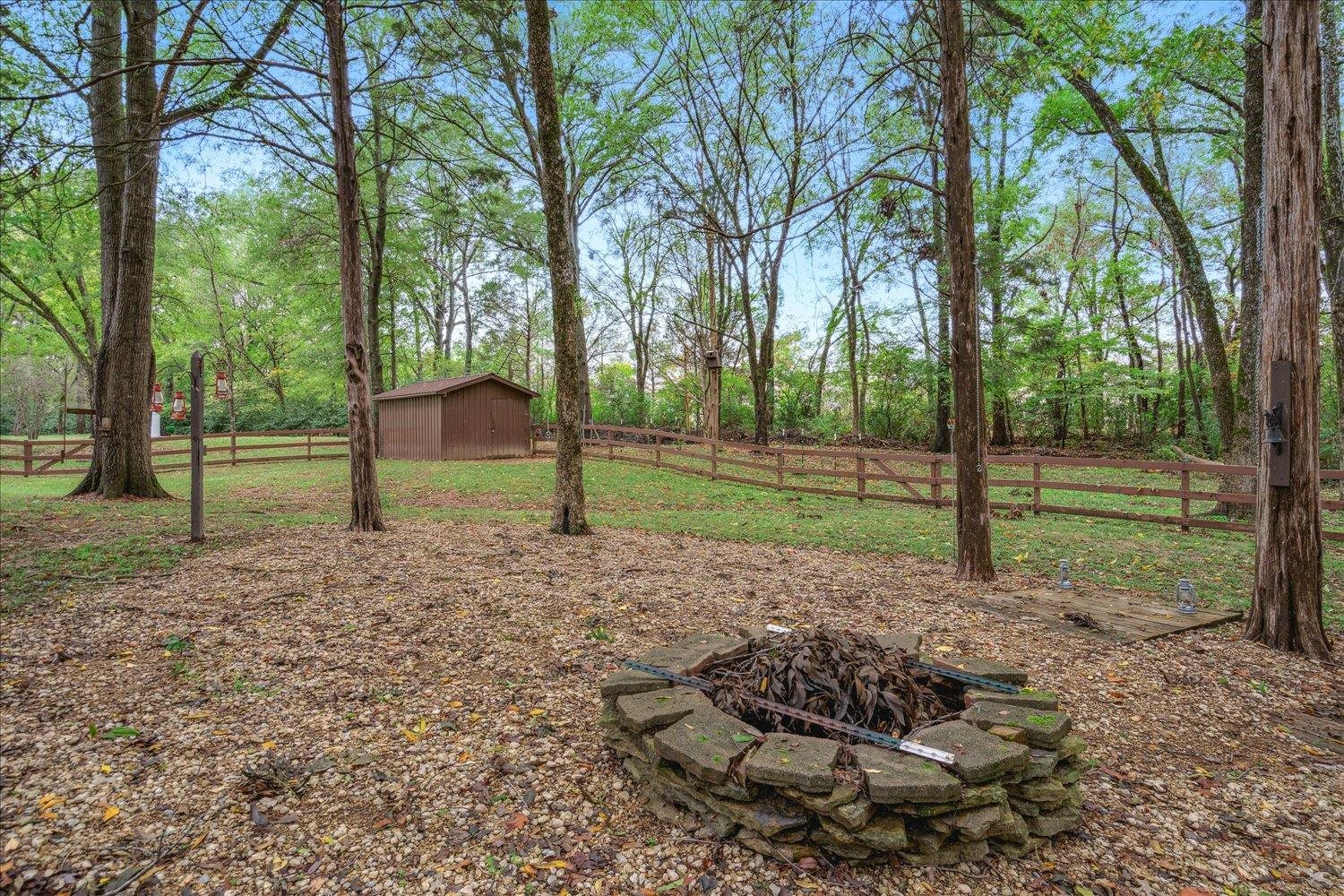 8450 Thor Road Memphis, TN 38018 - Photo 31 of 32 View of yard with a fire pit and a storage shed