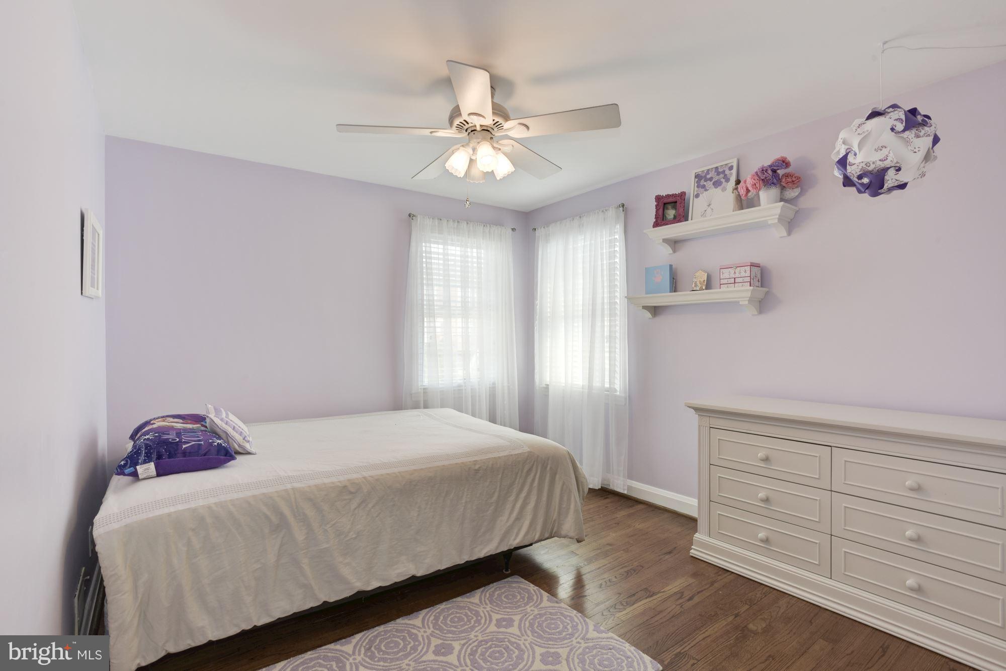 420 Stratford Road Baltimore, MD 21228 - Photo 14 of 26 a bedroom with a bed and a chandelier