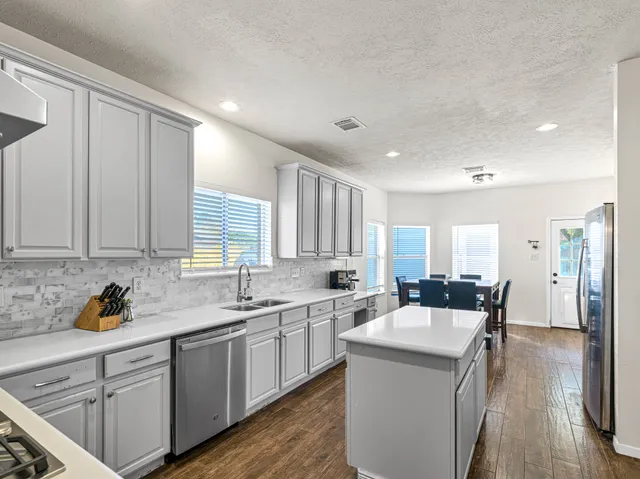 a living room with furniture ceiling fan and a window