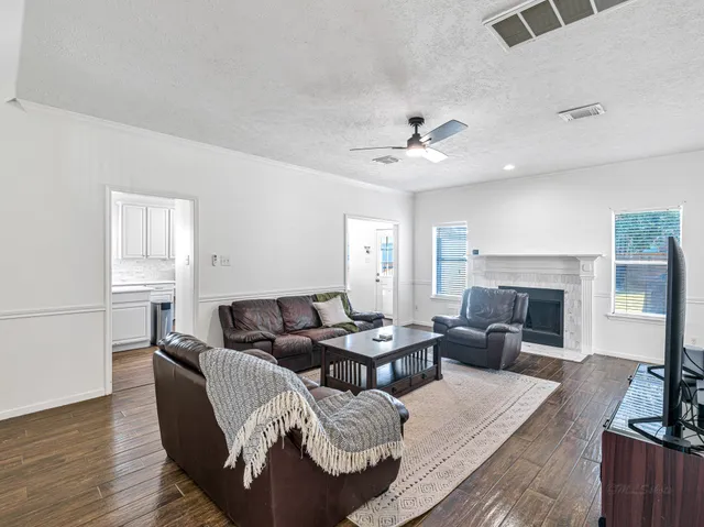 a bathroom with a sink a toilet and shower curtain