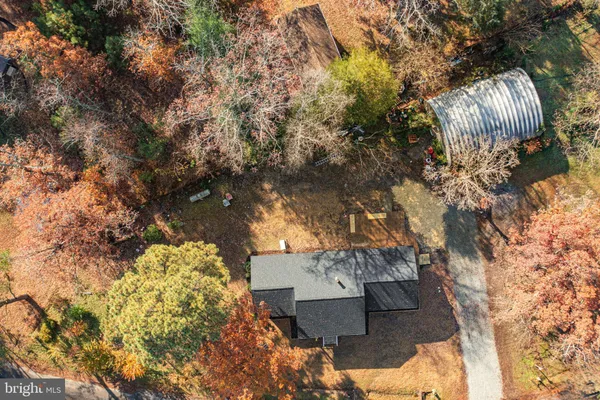 an aerial view of ocean and residential houses with outdoor space