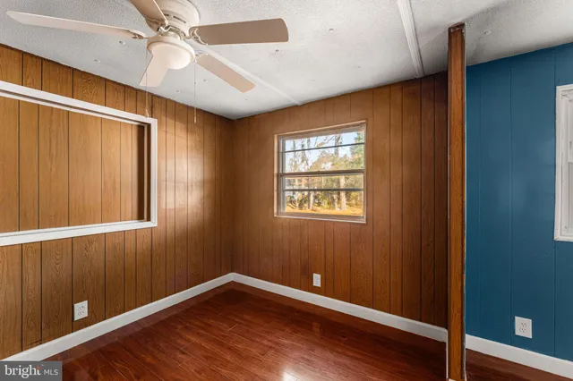 a large kitchen with granite countertop a stove sink and cabinets