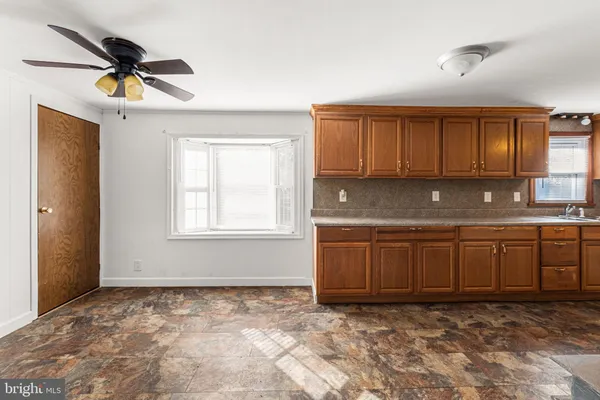 a kitchen with stainless steel appliances wooden cabinets a sink and a stove