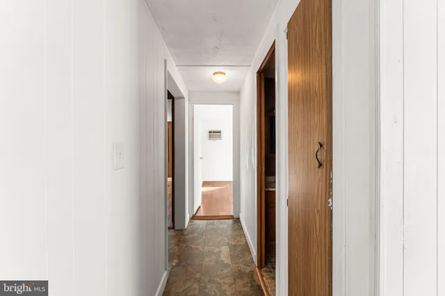 a view of a room with wooden floor and window