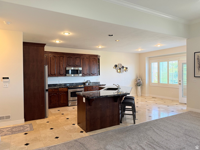 1562 Fairway Ridge Road Draper, UT 84020 - Photo 11 of 60 Kitchen featuring dark wood cabinetry, stainless steel appliances, and dark granite countertops