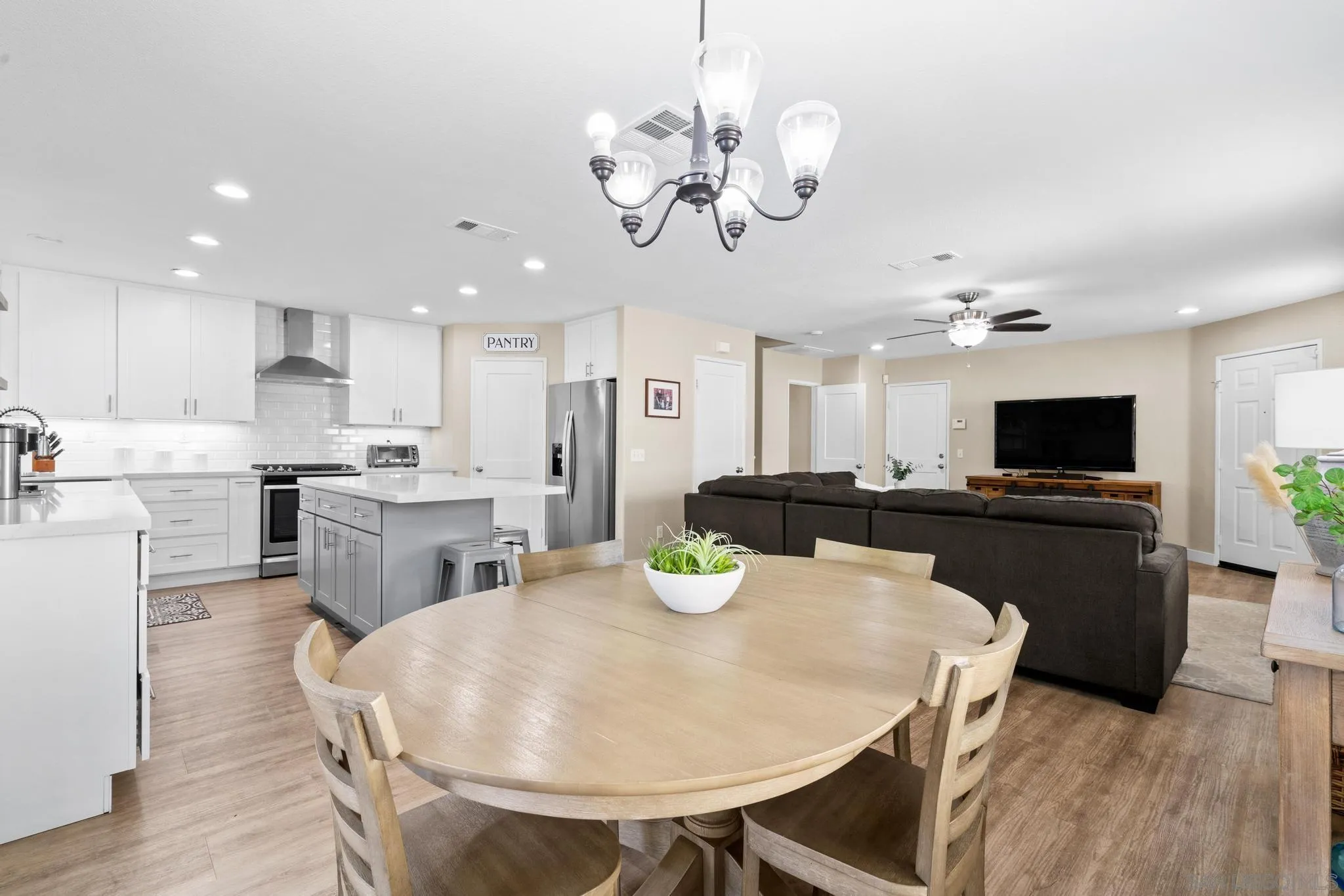 1942 Arbor Glen Escondido, CA 92025 - Photo 11 of 25 a kitchen with cabinets a sink stainless steel appliances and dining table