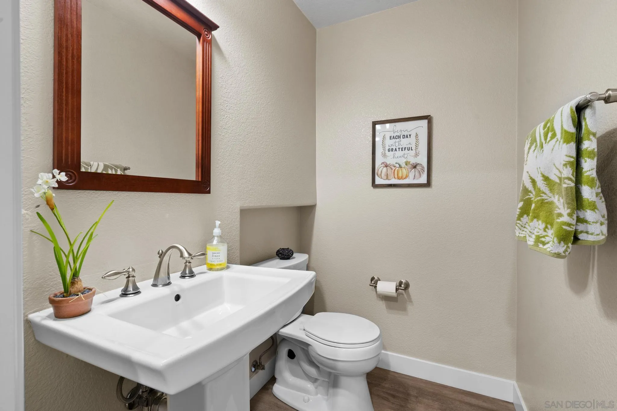 1942 Arbor Glen Escondido, CA 92025 - Photo 13 of 25 a bathroom with a sink mirror and toilet
