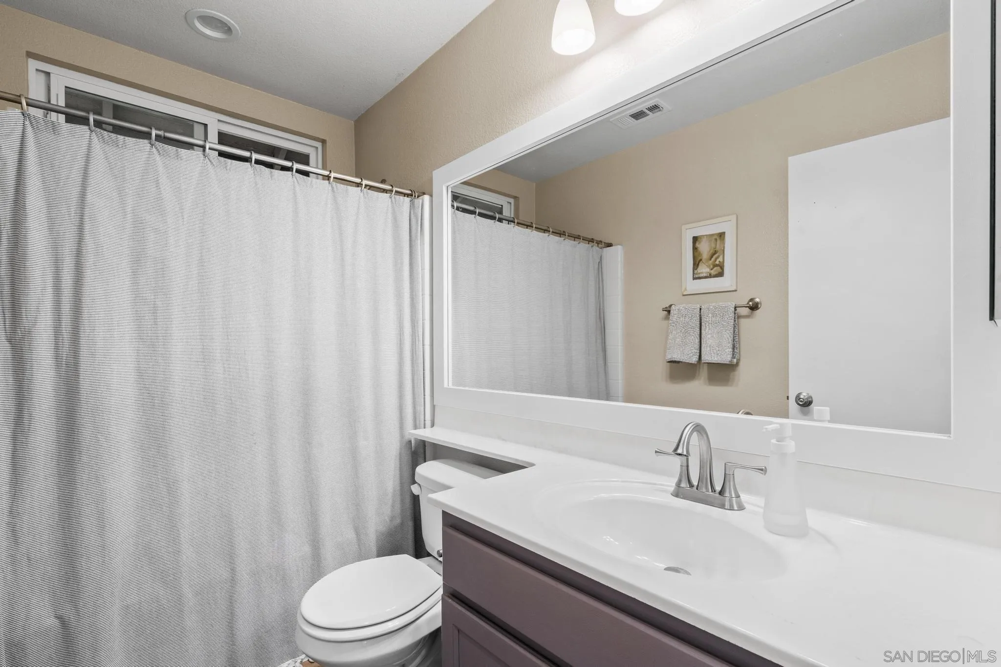 1942 Arbor Glen Escondido, CA 92025 - Photo 20 of 25 a bathroom with a sink toilet and shower