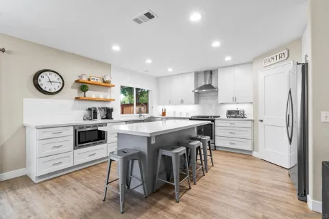 a kitchen with a sink and chairs