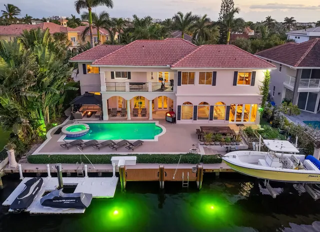 a view of a patio with table and chairs and potted plants
