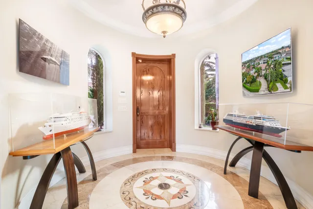 a view of a room that has a table and a chair in it