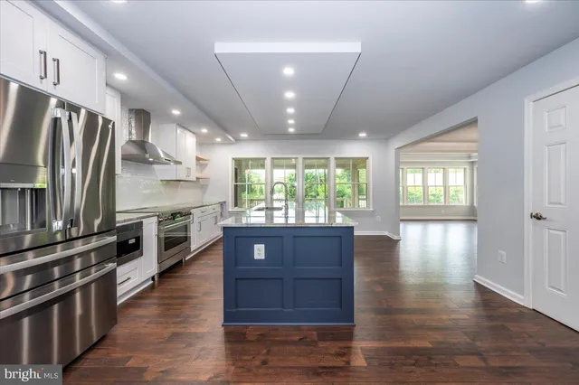 a white bath tub sitting in a bathroom next to a window