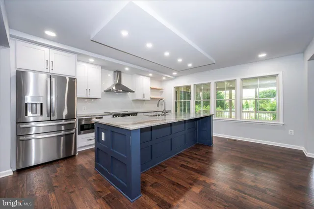a work room with furniture a large window and a potted plant
