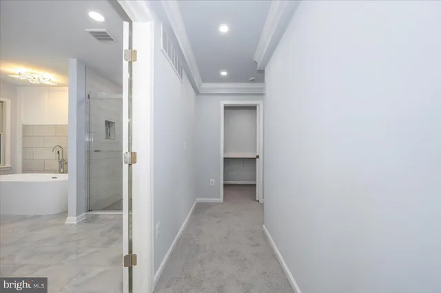 a view of an empty room with a ceiling fan