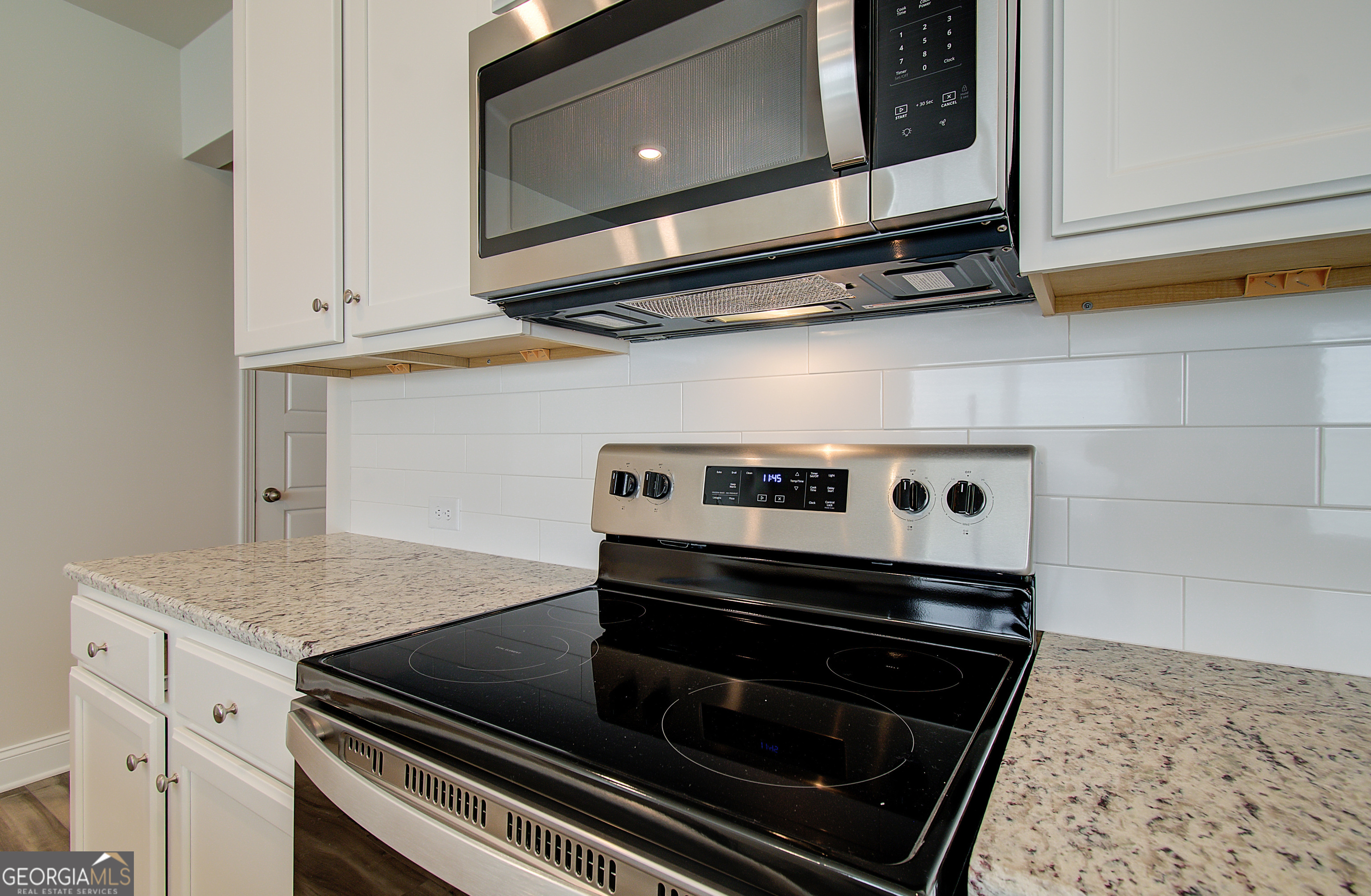 17 Butternut Way, Unit 118B Auburn, GA 30011 - Photo 34 of 53 a stove top oven sitting inside of a kitchen