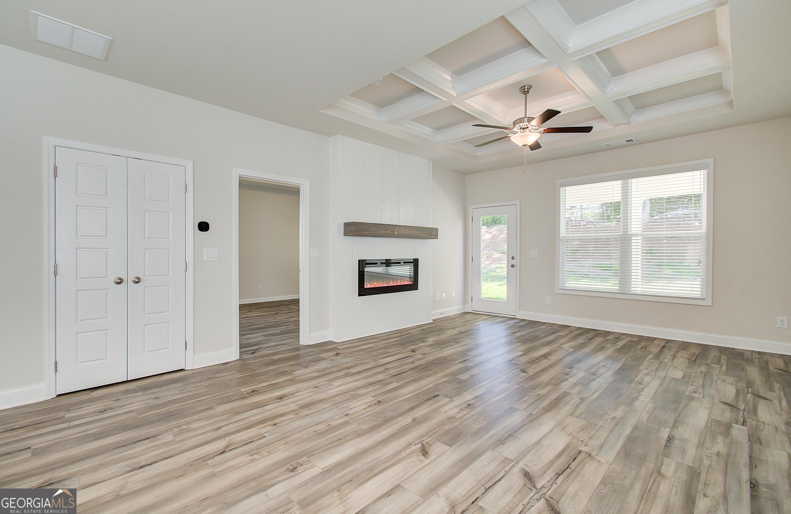 17 Butternut Way, Unit 118B Auburn, GA 30011 - Photo 38 of 53 a view of an empty room with a window and wooden floor