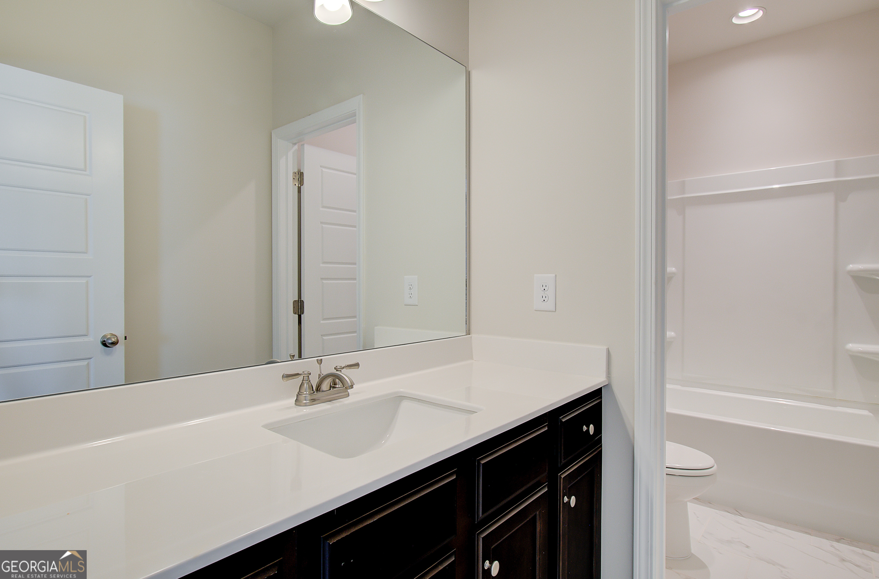 17 Butternut Way, Unit 118B Auburn, GA 30011 - Photo 45 of 53 a bathroom with a sink a shower and a mirror