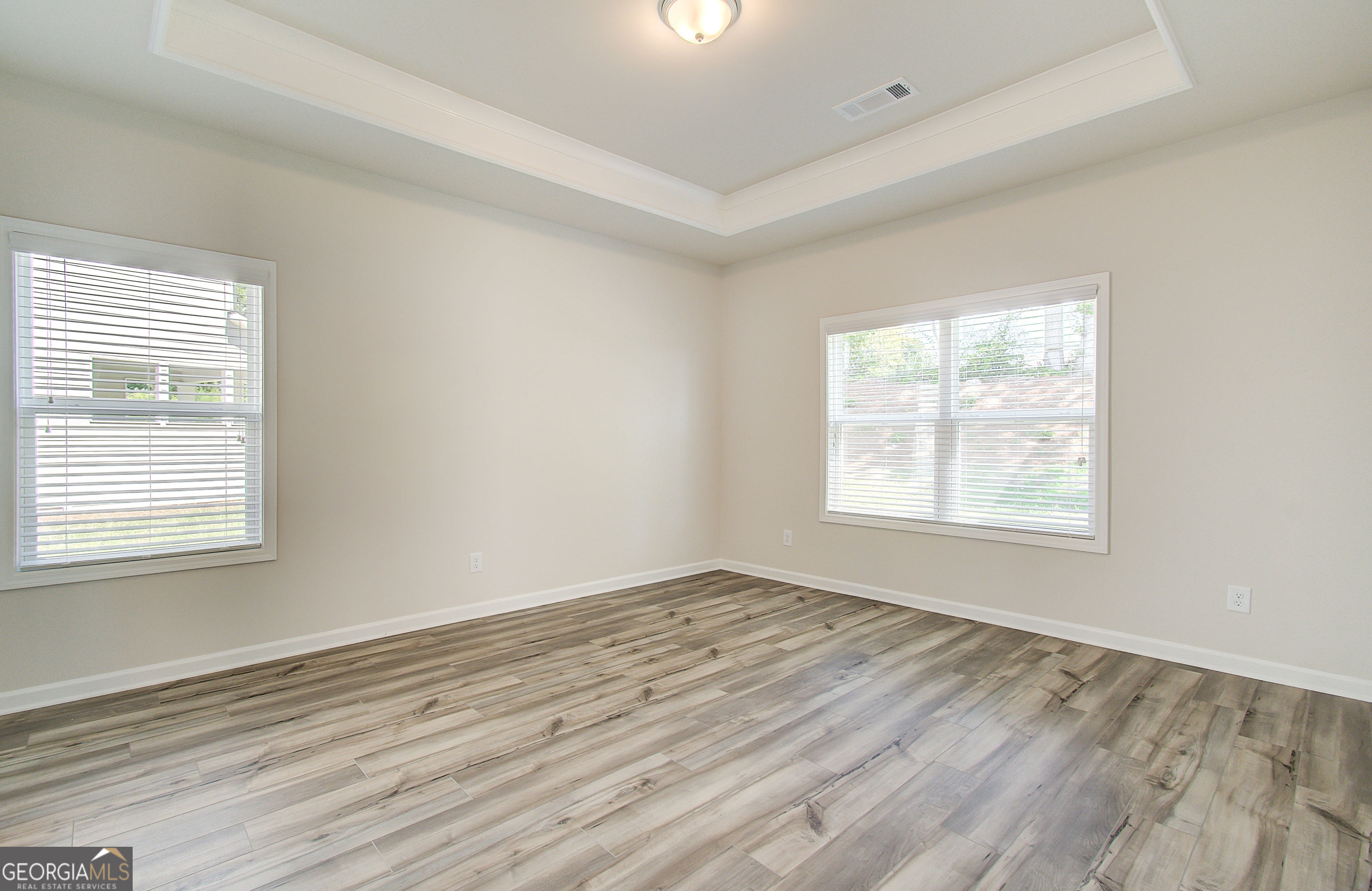17 Butternut Way, Unit 118B Auburn, GA 30011 - Photo 48 of 53 a view of an empty room with wooden floor and a window