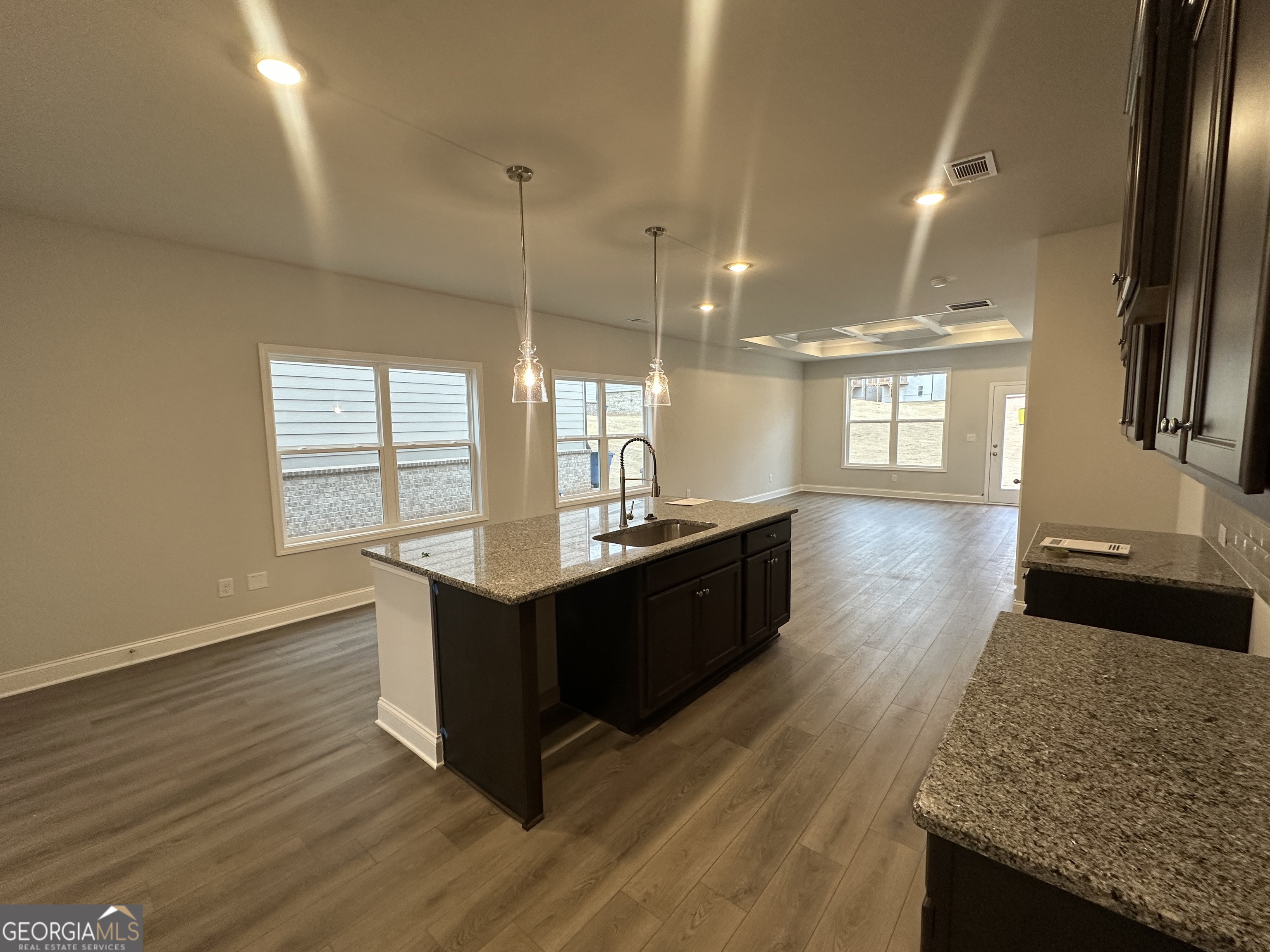 17 Butternut Way, Unit 118B Auburn, GA 30011 - Photo 5 of 53 a kitchen with stainless steel appliances granite countertop a sink a oven a counter space and wooden floor
