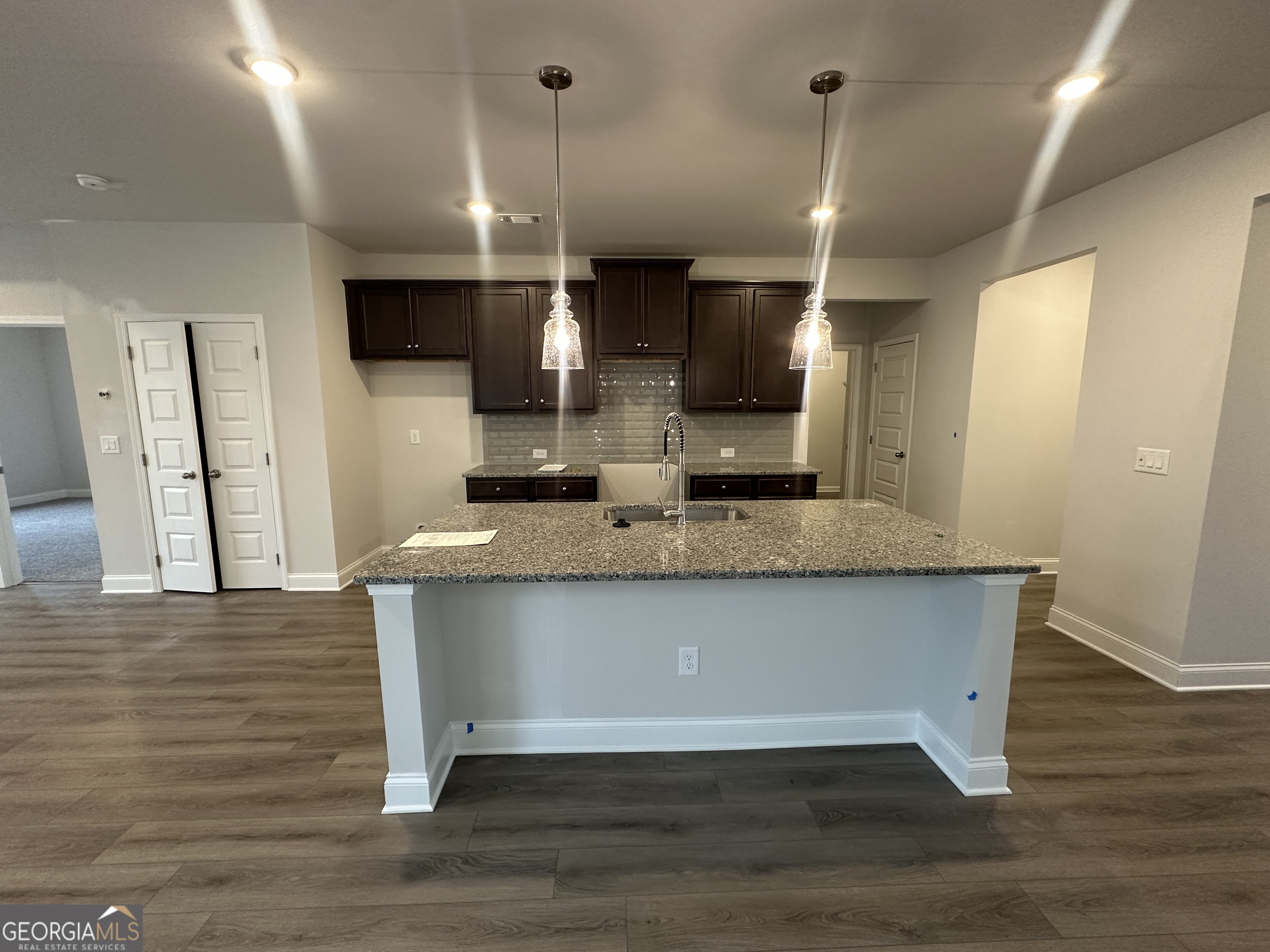 17 Butternut Way, Unit 118B Auburn, GA 30011 - Photo 6 of 53 a view of outdoor kitchen with stainless steel appliances kitchen island wooden floor and window