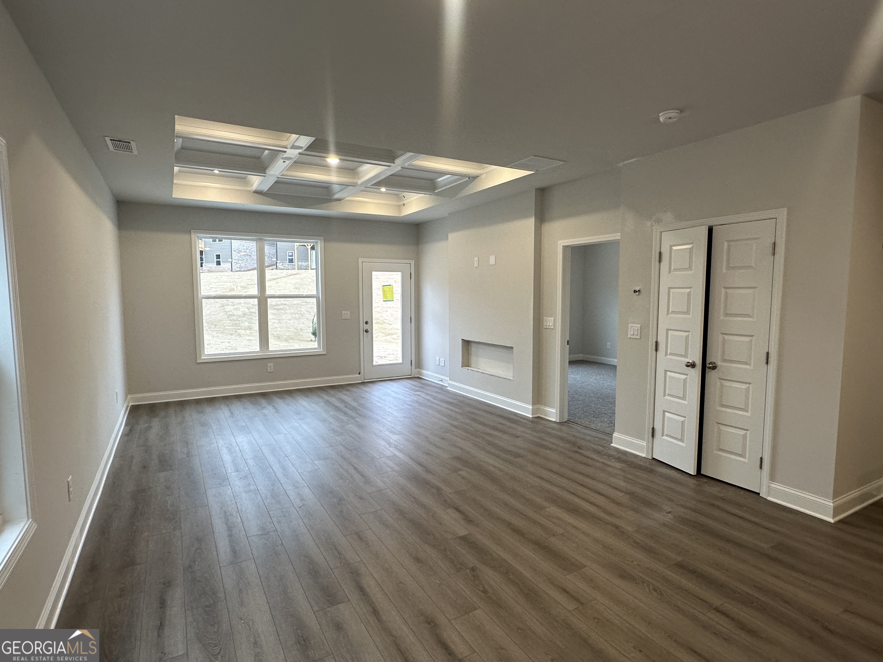 17 Butternut Way, Unit 118B Auburn, GA 30011 - Photo 7 of 53 an empty room with wooden floor and windows