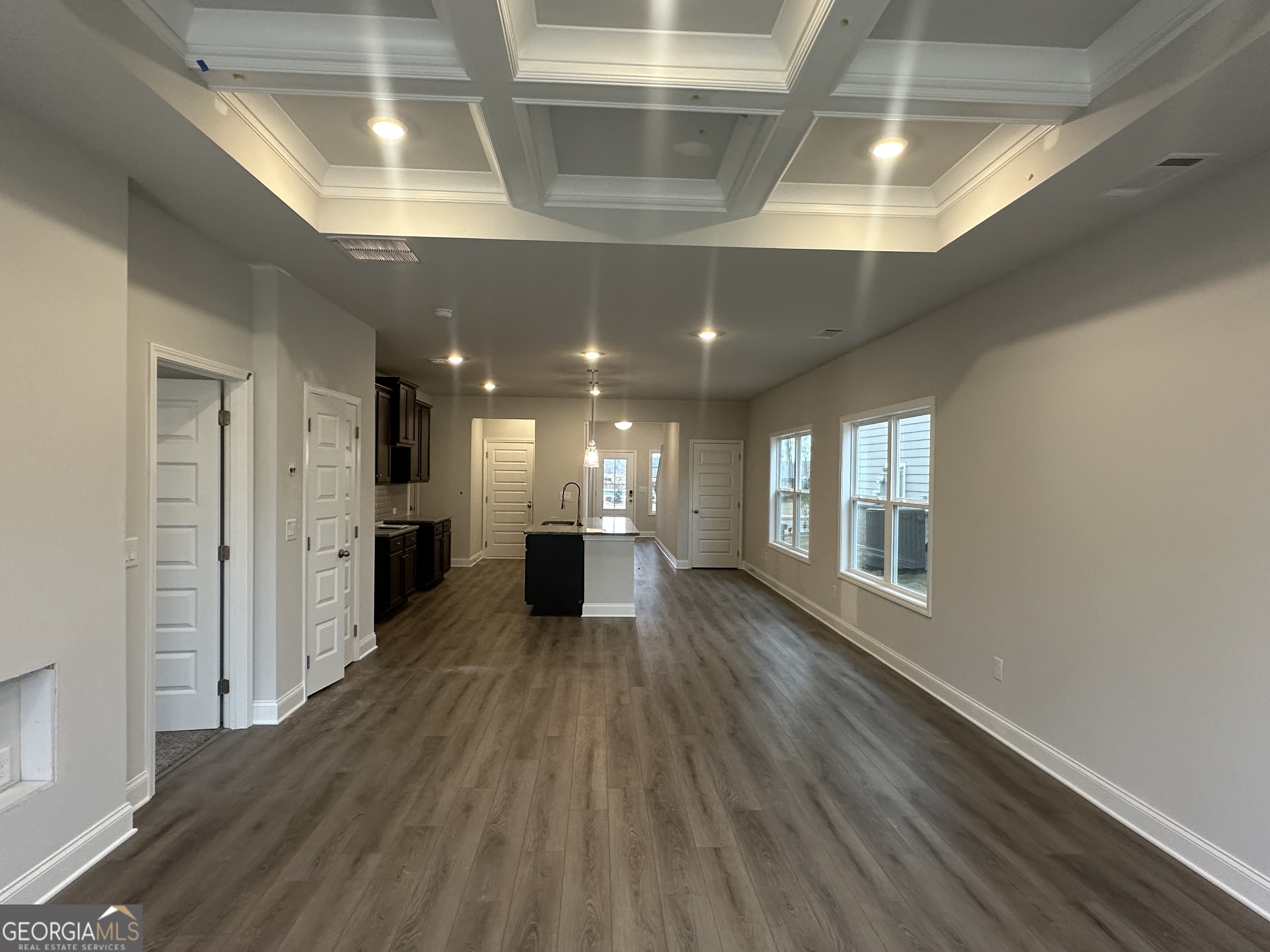 17 Butternut Way, Unit 118B Auburn, GA 30011 - Photo 8 of 53 a view of an empty room with wooden floor and a kitchen