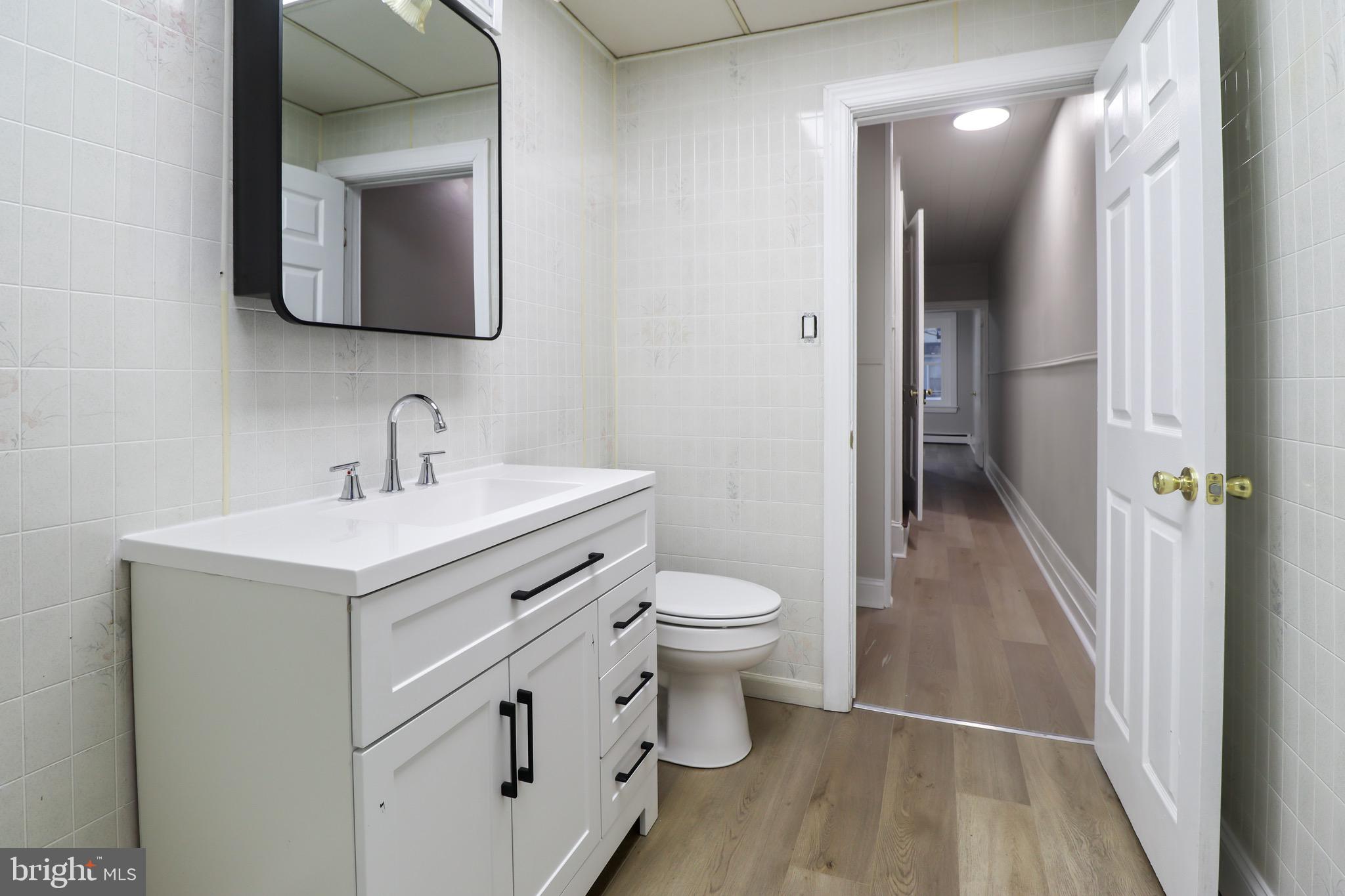 77 7th Street Salem, NJ 08079 - Photo 9 of 15 a bathroom with a toilet sink and mirror