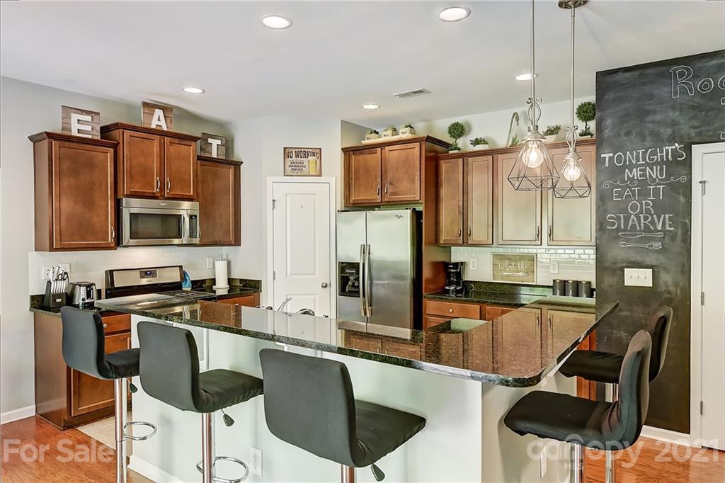 923 Rook Road Charlotte, NC 28216 - Photo 14 of 36 a kitchen with stainless steel appliances granite countertop a sink and a refrigerator