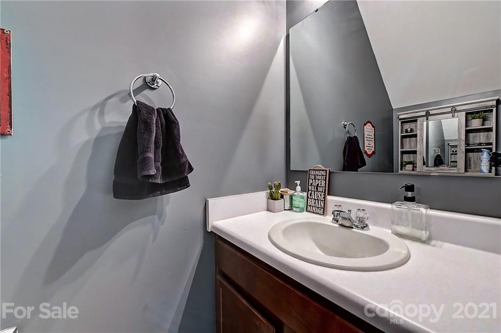 923 Rook Road Charlotte, NC 28216 - Photo 16 of 36 a bathroom with a sink and a mirror