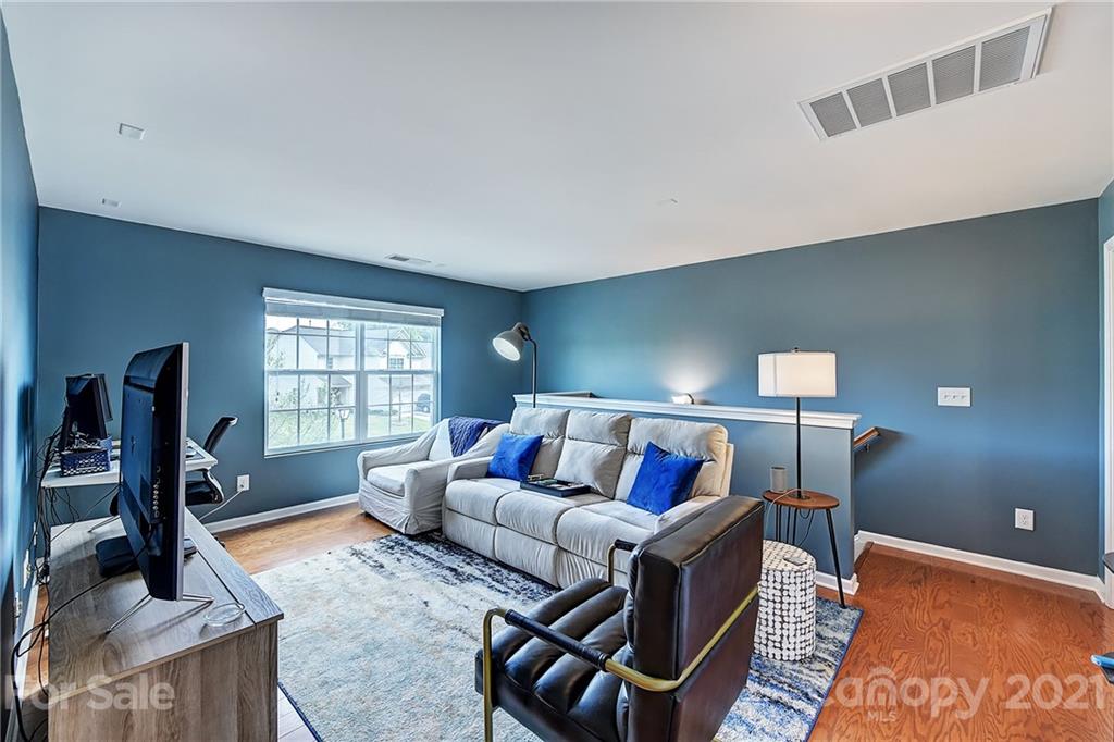 923 Rook Road Charlotte, NC 28216 - Photo 17 of 36 a living room with furniture a flat screen tv and a window