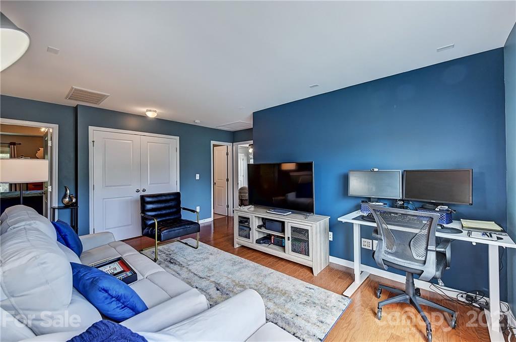 923 Rook Road Charlotte, NC 28216 - Photo 20 of 36 a living room with furniture and a flat screen tv