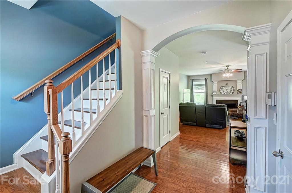 923 Rook Road Charlotte, NC 28216 - Photo 3 of 36 a view of a hallway with wooden floor and staircase