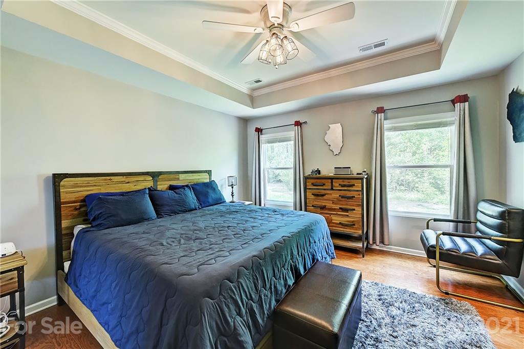 923 Rook Road Charlotte, NC 28216 - Photo 21 of 36 a bedroom with a bed next to a window with the outer view