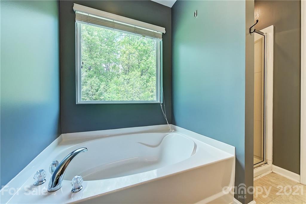 923 Rook Road Charlotte, NC 28216 - Photo 25 of 36 a bathroom with a tub and shower
