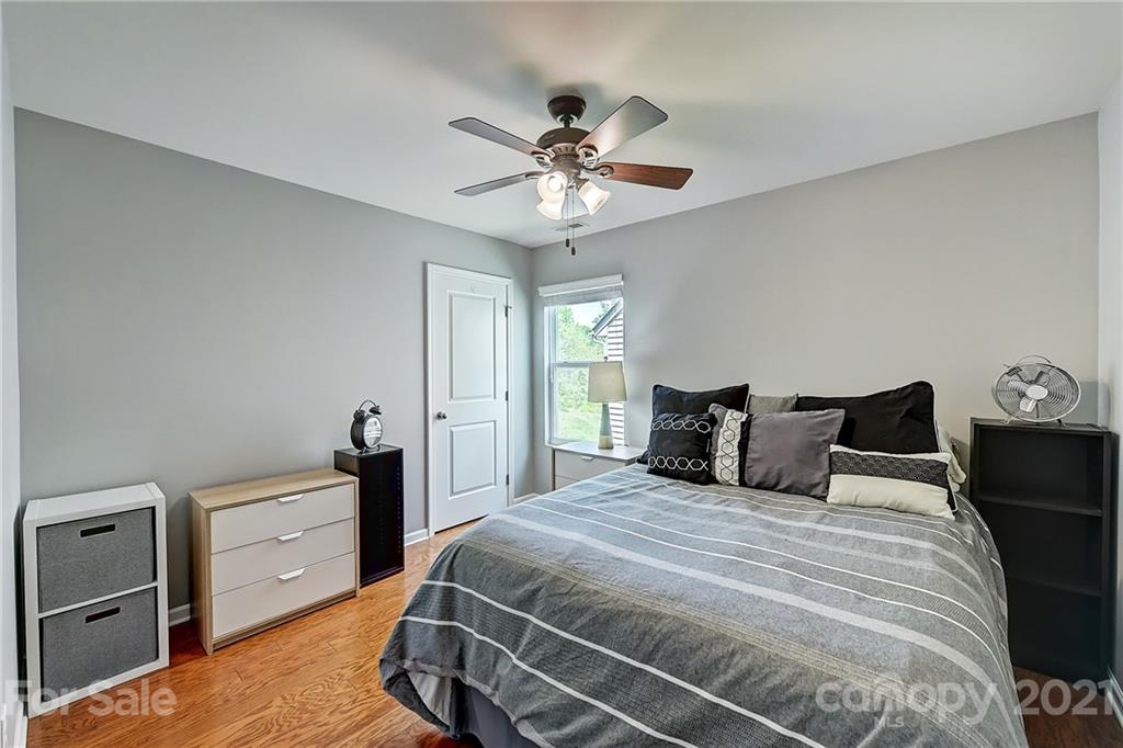 923 Rook Road Charlotte, NC 28216 - Photo 26 of 36 a bedroom with a bed and a chandelier