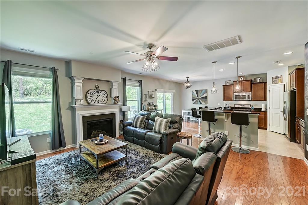 923 Rook Road Charlotte, NC 28216 - Photo 5 of 36 a living room with furniture a fireplace a flat screen tv and a window