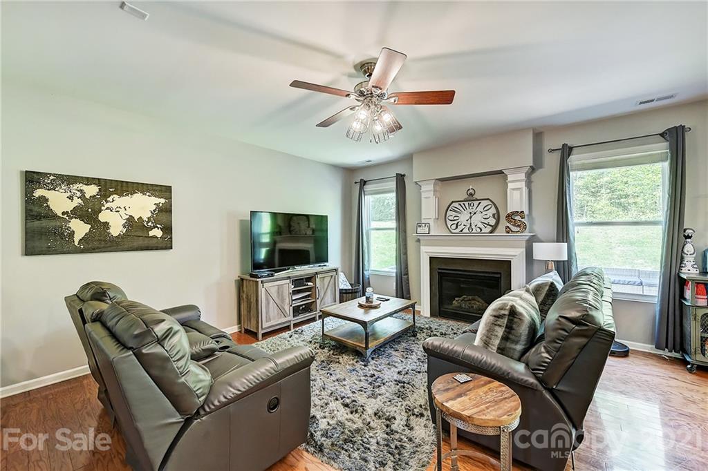923 Rook Road Charlotte, NC 28216 - Photo 6 of 36 a living room with furniture a flat screen tv and a fireplace