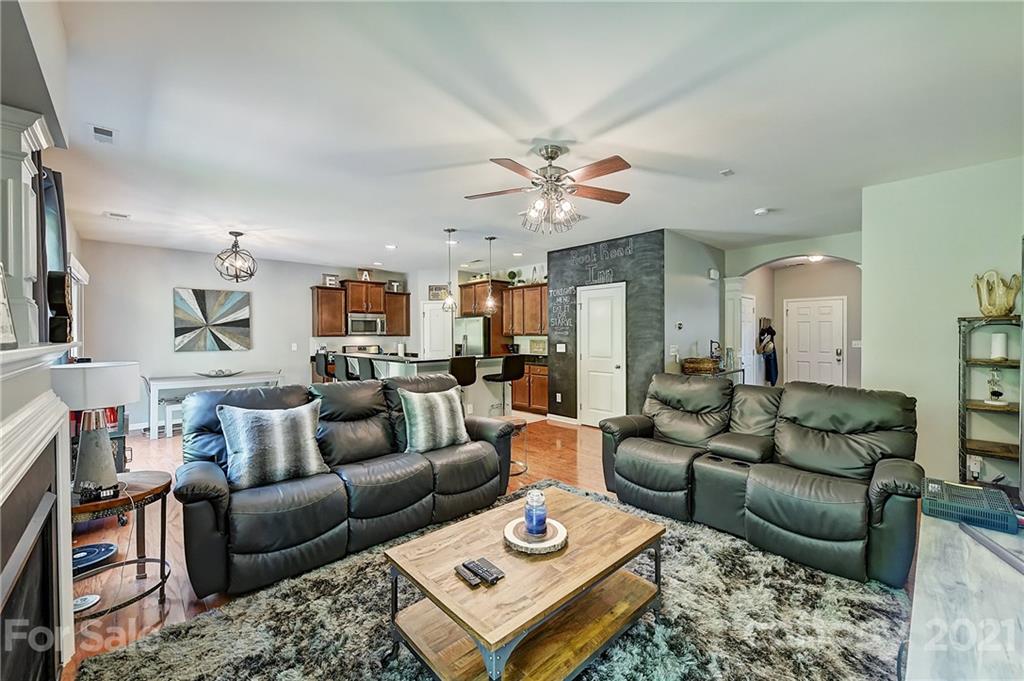 923 Rook Road Charlotte, NC 28216 - Photo 7 of 36 a living room with furniture a rug and a chandelier
