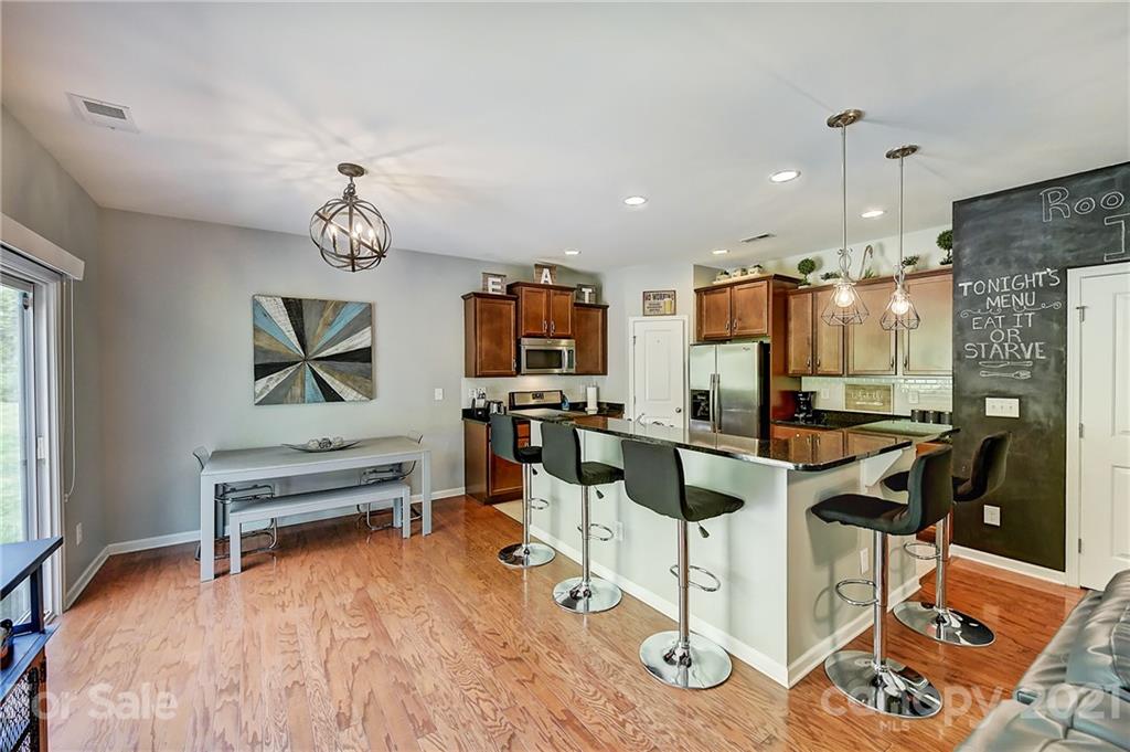 923 Rook Road Charlotte, NC 28216 - Photo 9 of 36 a view of a kitchen with dining table and chairs